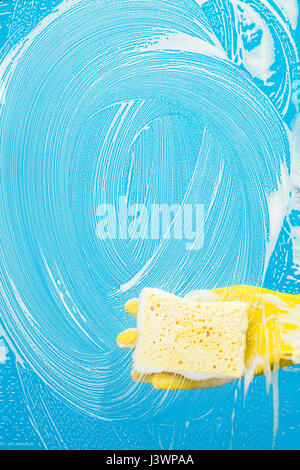 Man with sponge cleaning window Stock Photo