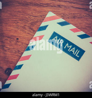 Retro Photo Of An Old Air Mail Envelope Of A Rustic Wooden Background Stock Photo