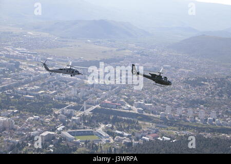 A USN MH-60S Knight hawk helicopter (left) flies with a Montenegrin Air Force Soko H-42 Gazelle helicopter April 23, 2015 over Podgorica, Montenegro.    (photo by Montenegro Air Force Photo /Montenegro Air Force  via Planetpix) Stock Photo