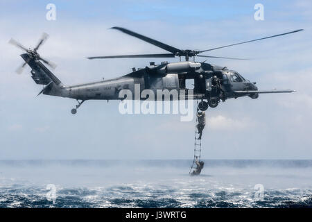 U.S. special forces soldiers climb onto a USAF HH-60G Pave Hawk helicopter during rope-ladder recovery training September 22, 2015 near Okinawa, Japan.    (photo by John Linzmeier /US Air Force  via Planetpix) Stock Photo
