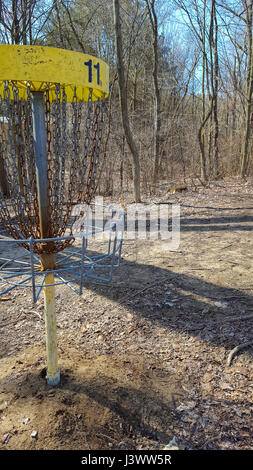 disc golf basket with number in spring woods Stock Photo