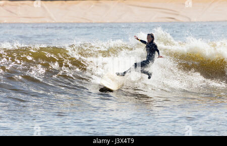 Conwy County, Wales, UK. 8th May, 2017. UK Weather, Glorious sunshine on the west coast of the UK today including North Wales. A surfur enjoying the thrills and weather at Surf Snowdonia in the Cowny Valley the worlds first artificial surfing lake – Credit: DGDImages/Alamy Live News Stock Photo