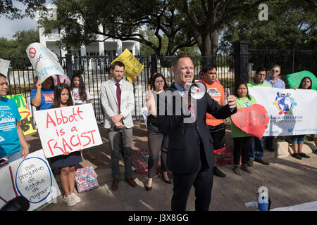 Austin, Texas, USA. 8th May, 2017. State Rep. Rafael Anchia yells as immigrant Texans protest at the Texas Governor's Mansion downtown Austin after Gov. Greg Abbott privately signed on Faebook Live an anti-immigrant bill that would require Texas police officers to question immigration status on detained suspects. Credit: Bob Daemmrich/Alamy Live News Stock Photo