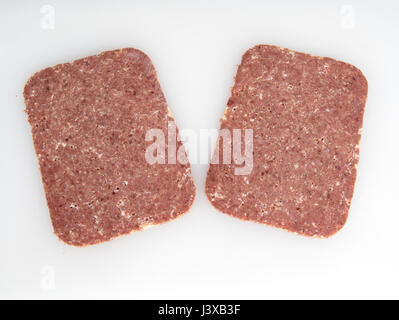 Two slices of Corned Beef on a white background Stock Photo