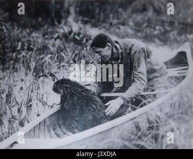 Portrait of Archibald Belaney (known as Grey Owl, 1888-1938) with a  beaver in the Riding Mountain National Park, Manitoba, Canada Stock Photo
