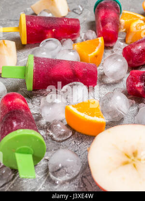 Sangria popsicles with fruits and ice on gray background Stock Photo