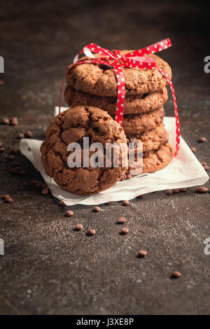 Stack of freshly baked chocolate chip cookies on rustic background Stock Photo