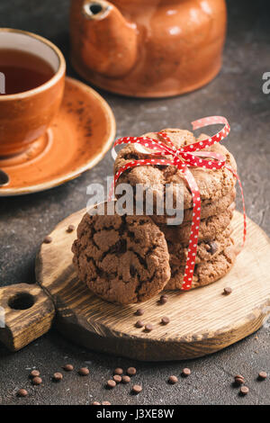 freshly baked chocolate chip cookies with tea on rustic background Stock Photo