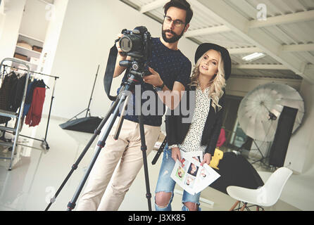 Photographers mounting camera on tripod in photography studio Stock Photo