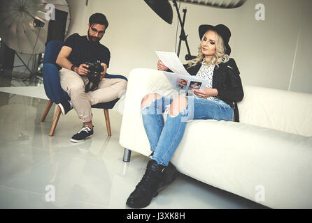 Photographer and stylist reviewing work in photography studio Stock Photo