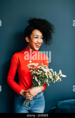 Portrait of happy florist holding cut flowers Stock Photo