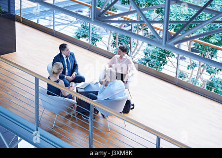 High angle view of businessmen and businesswomen meeting on office balcony Stock Photo