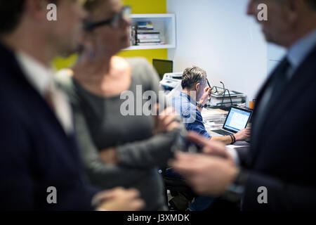 Colleagues in office having discussion Stock Photo