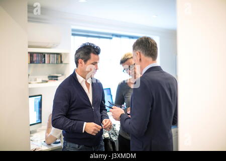 Colleagues in office having discussion Stock Photo