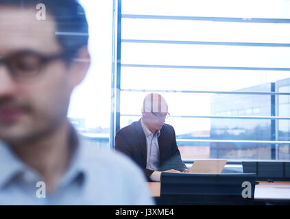 Window view of businessmen working in office Stock Photo