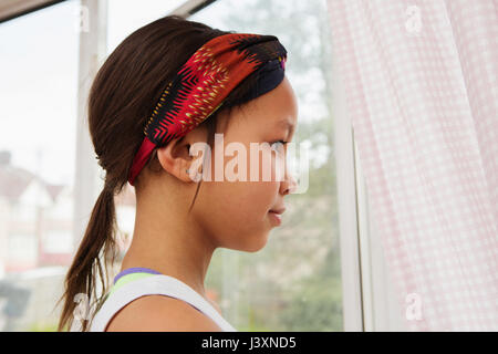 Girl looking out of window Stock Photo