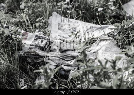 Newspaper Rubbish on the Ground Stock Photo