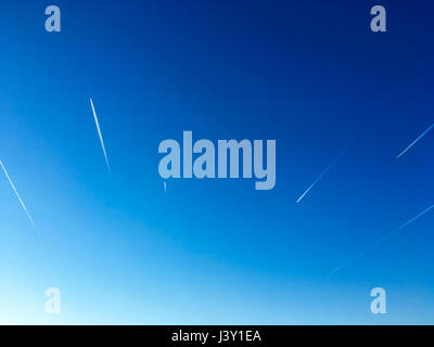 Airplane Trails On Blue Sky Stock Photo