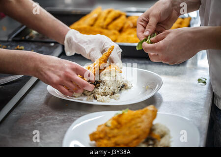 Busy chefs at work in the restaurant kitchen Stock Photo
