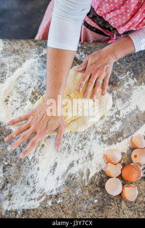 Mature woman making home made pasta, overhead view Stock Photo