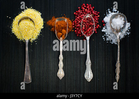 Antique spoons with different spices Stock Photo