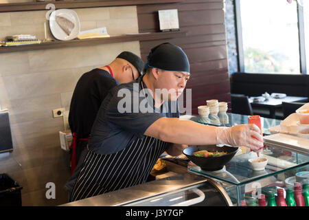 Chefs in kitchen preparing food Stock Photo