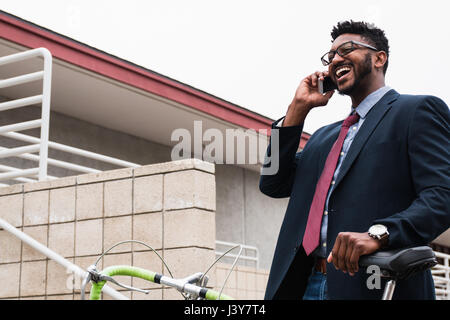 Young businessman making smartphone call on railway station platform Stock Photo