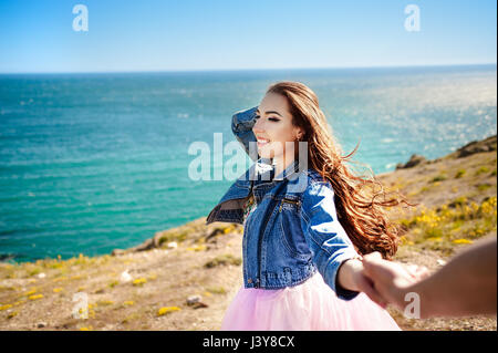 https://l450v.alamy.com/450v/j3y8cx/follow-me-there-beautiful-young-woman-holds-the-mans-hand-and-indicate-a-idyllic-place-to-relax-best-friends-couple-walking-hand-in-hand-and-discover-new-place-carefree-modern-travel-concept-j3y8cx.jpg