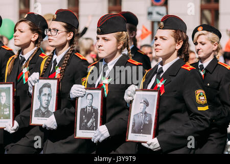 The Marching Formation Of Cadet Girls From Gomel State Cadet School With Portraits Of WW2 Heroes In Ceremonial Parade Procession. Celebration Of Victo Stock Photo