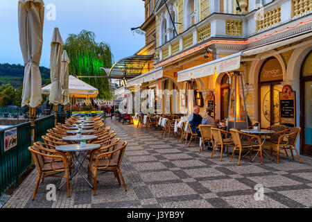 PRAGUE, CZECH REPUBLIC - SEPTEMBER 22, 2015: People sitting on restaurant terrace in Prague - capital and largest city of Bohemia, fifth most visited  Stock Photo