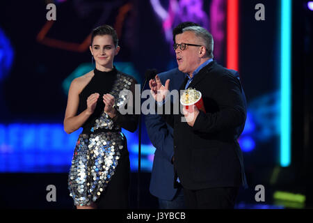 Emma Watson and director Bill Condon accept Movie of the Year for 'Beauty and the Beast' on stage during the 2017 MTV Movie and TV Awards held at The Shrine Auditorium in Los Angeles, USA. Stock Photo