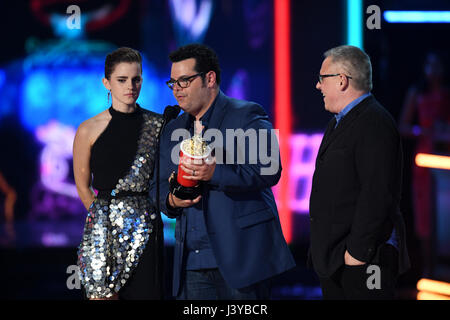 Emma Watson, Josh Gad and director Bill Condon accept Movie of the Year for 'Beauty and the Beast' on stage during the 2017 MTV Movie and TV Awards held at The Shrine Auditorium in Los Angeles, USA. Stock Photo