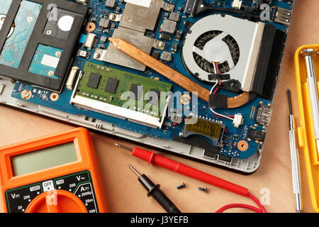 Disassembled laptop and equipment for computer repairing. Stock Photo