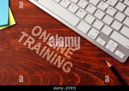 Online training written on a wooden surface. E-learning concept. Stock Photo