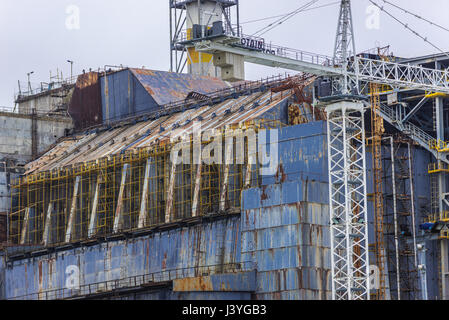 Close up on old steel and concrete sarcophagus of reactor No 4 of Chernobyl Nuclear Power Plant in Zone of Alienation in Ukraine Stock Photo