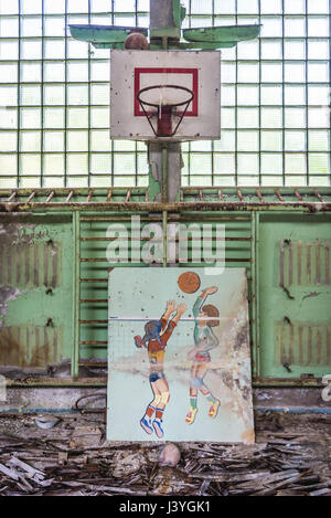 Basketball court in High school No 2 in Pripyat ghost city of Chernobyl Nuclear Power Plant Zone of Alienation in Ukraine Stock Photo