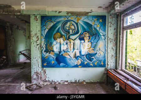 Soviet poster in High school No 2 in Pripyat ghost city of Chernobyl Nuclear Power Plant Zone of Alienation in Ukraine Stock Photo