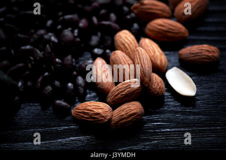 Almonds and sunflower seeds in chocolate on a dark background. Studio. Stock Photo