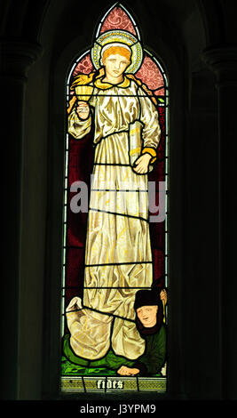 Fides, Faith, stained glass window by Burne-Jones, 1865, detail from Faith Hope and Charity' window, Sculthorpe church, Norfolk, England UK Stock Photo