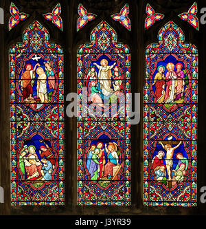 Stained Glass window by Ward & Hughes, showing a baptism, Ascension and Christ with Moses, designed by  Thomas Willement, 1859, Sculthorpe church Stock Photo