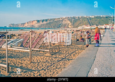 Fishermen's wives using racks for drying fish on the beach in Nazare