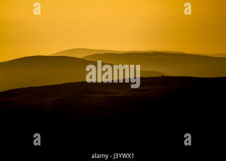 Hill in Clwyd at sunset in Spring, showing landscape recedeing in to distance Stock Photo