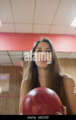 A young woman bowling. Stock Photo