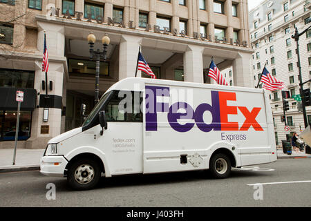 FedEx delivery truck parked in front of office building - USA Stock Photo
