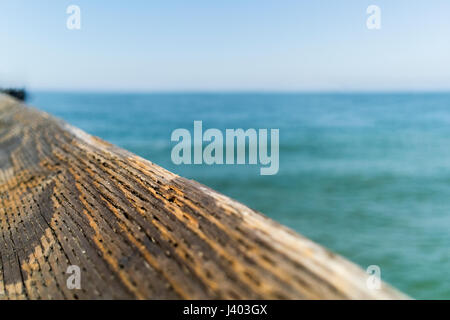 Weathered wood rail on a blue sky. Stock Photo