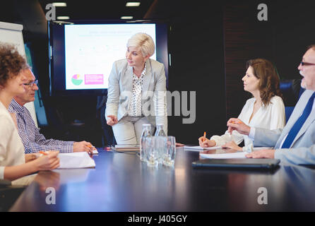Senior adult woman leading in conference Stock Photo