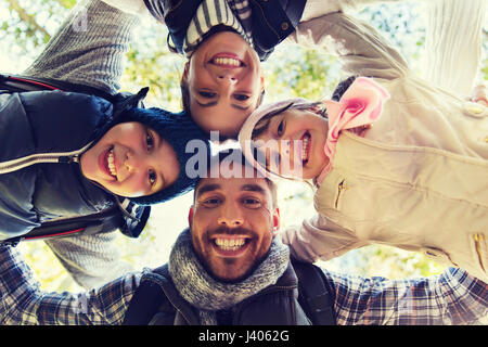 happy family faces outdoors at camp in woods Stock Photo