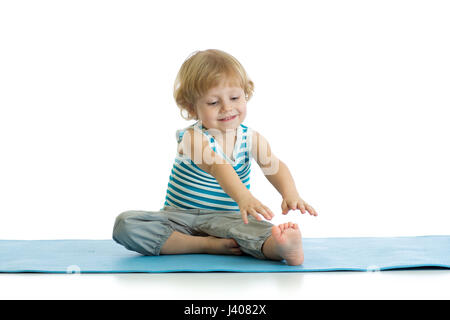 Kid child doing a set of exercises for stretching. Stock Photo