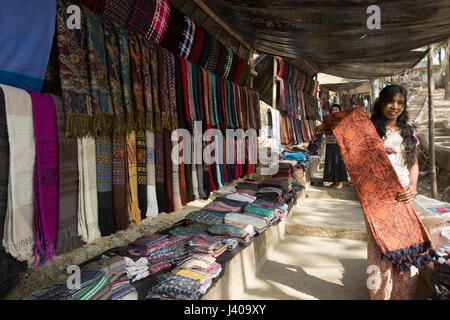 Ethnic girls selling traditional fabrics at Moheskhali Island. Cox’s Bazar, Bangladesh. Stock Photo