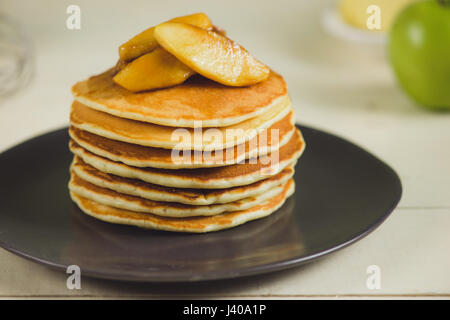 Pancakes with apple on table. Breakfast, snacks. Pancakes Day. Stock Photo